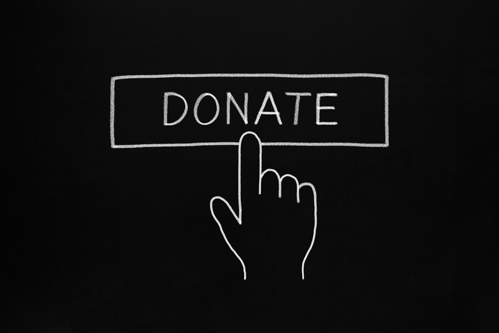 Hand clicking donate button after seeing strong non-profit marketing