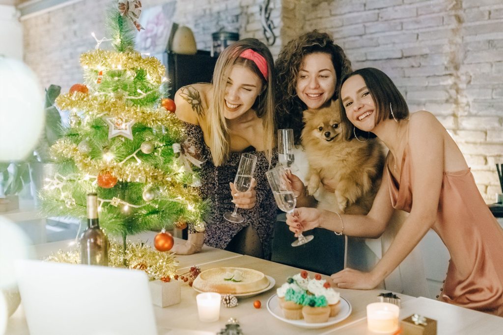 Three roommates celebrating Christmas with friends virtually.