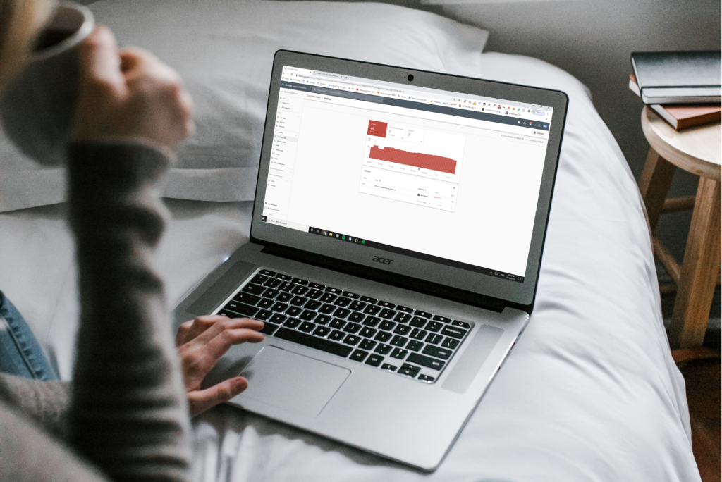 Woman with laptop open and Google Search Console Core Web Vitals report on her screen.