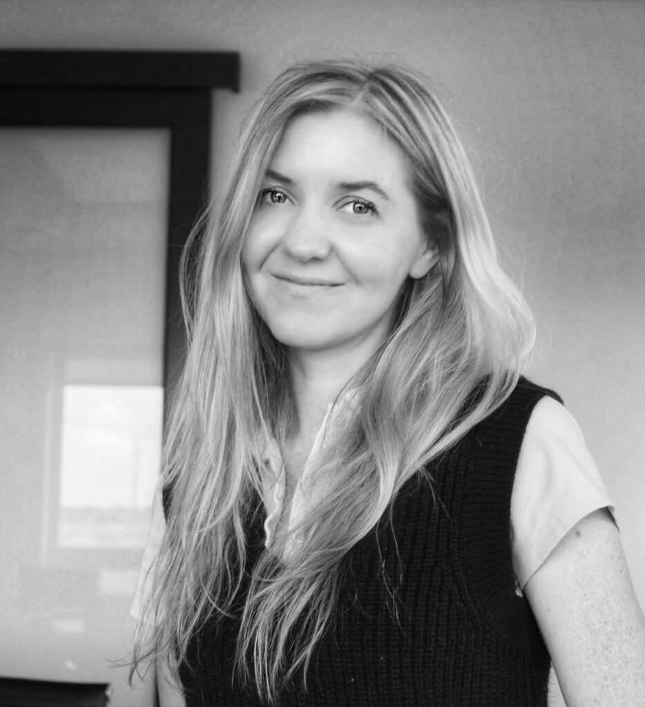 A black and white headshot of Chelsey Belec