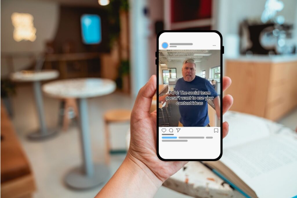 Image of an iPhone user looking at Bluetrain's Instagram post in a cafe.